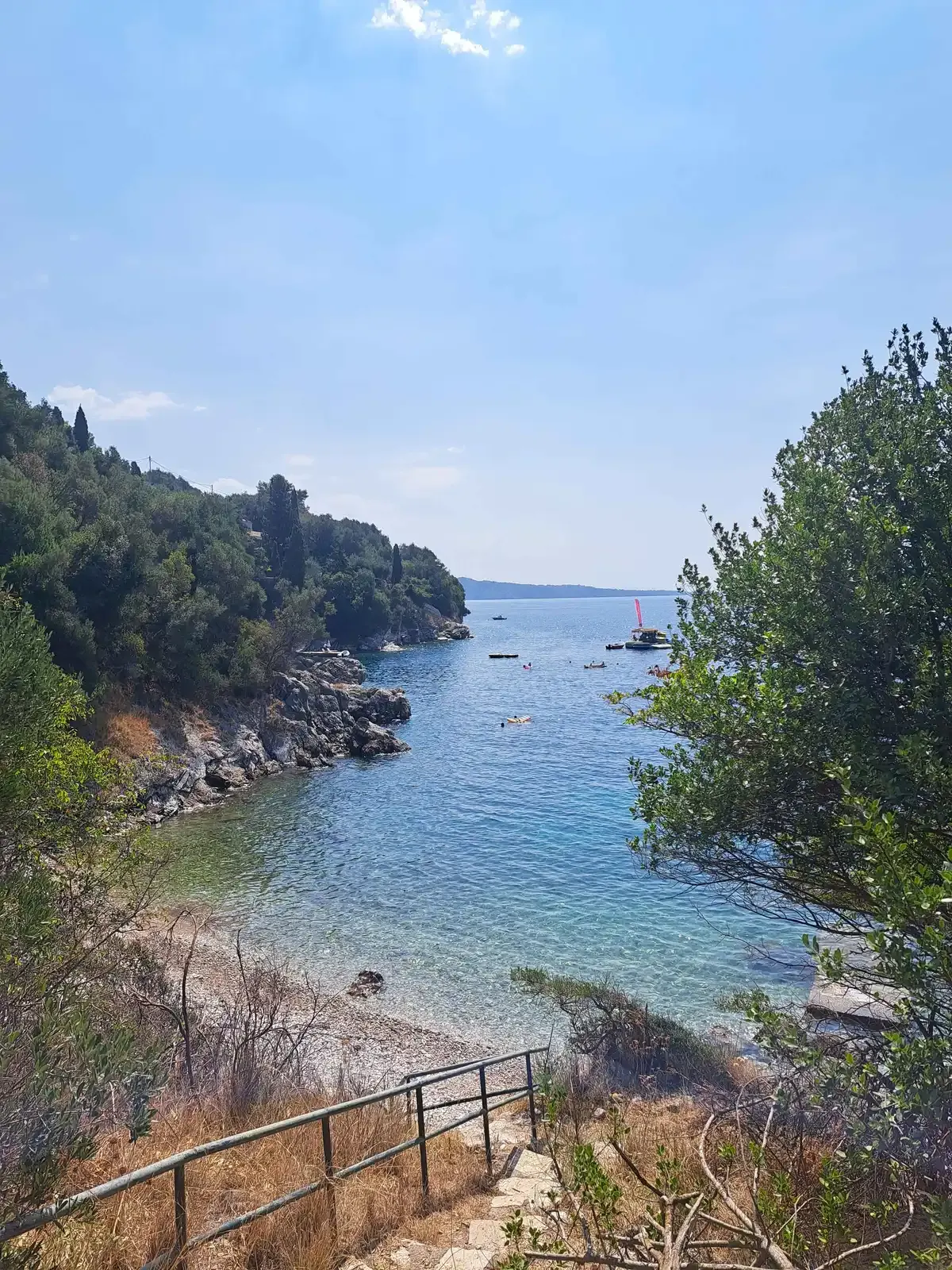 A pebble cove with clear water on the northeast coast near Kalami on a Corfu boat tour