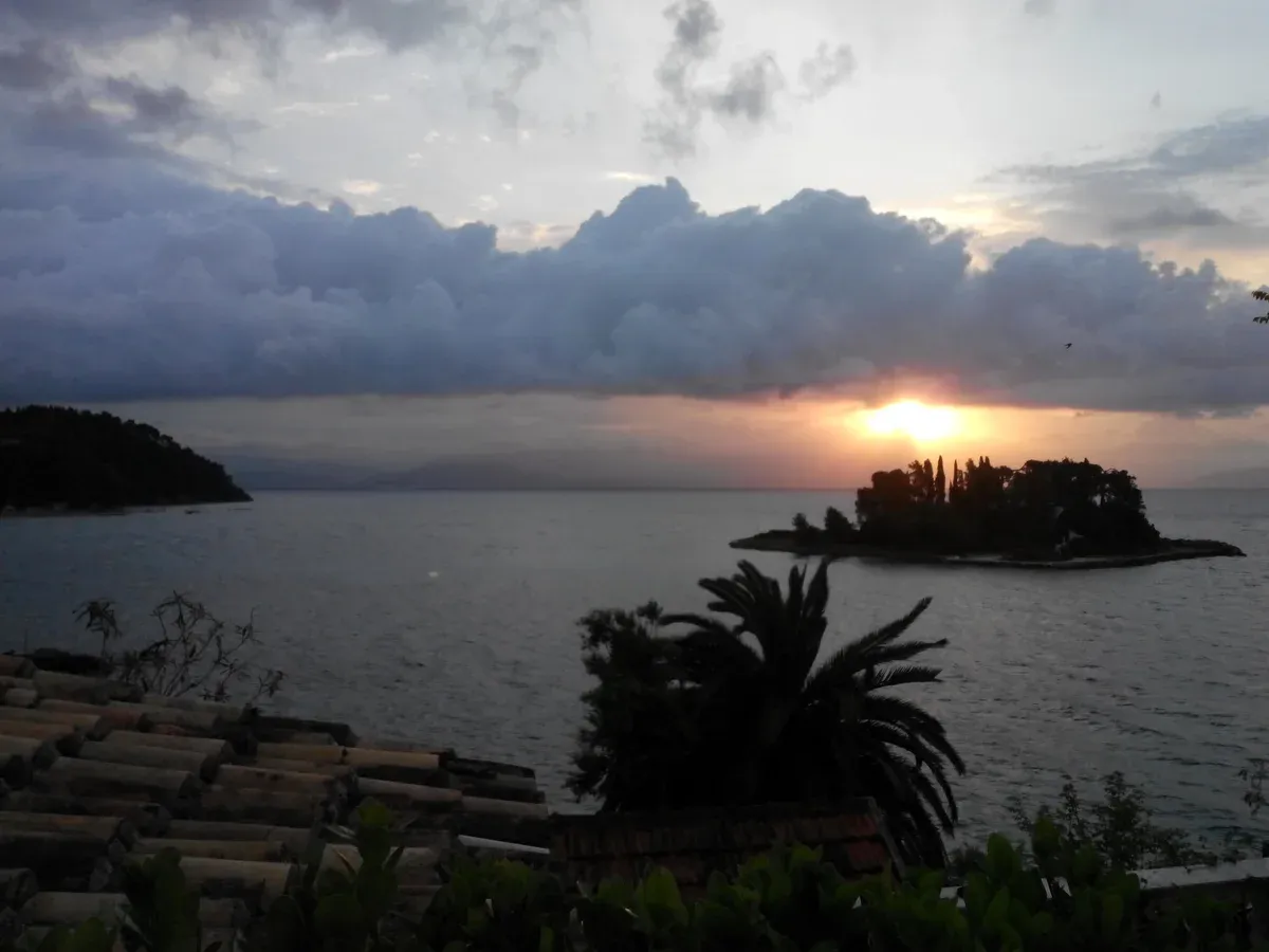 Pontikonisi, Mouse Island, at sunset off Corfu Town on a sunset Corfu boat tour